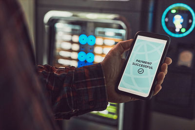 Consumer paying for product at vending machine using contactless method of payment with mobile phone