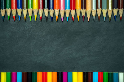 High angle view of multi colored pencils in row