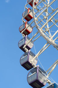 Closeup of multicolored tempozan ferris wheel in amusement park with blue sky in tbilisi, georgia