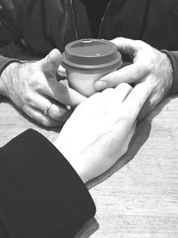 Close-up of hand holding coffee cup