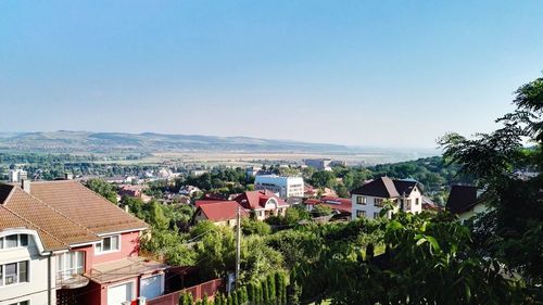 High angle view of houses against blue sky