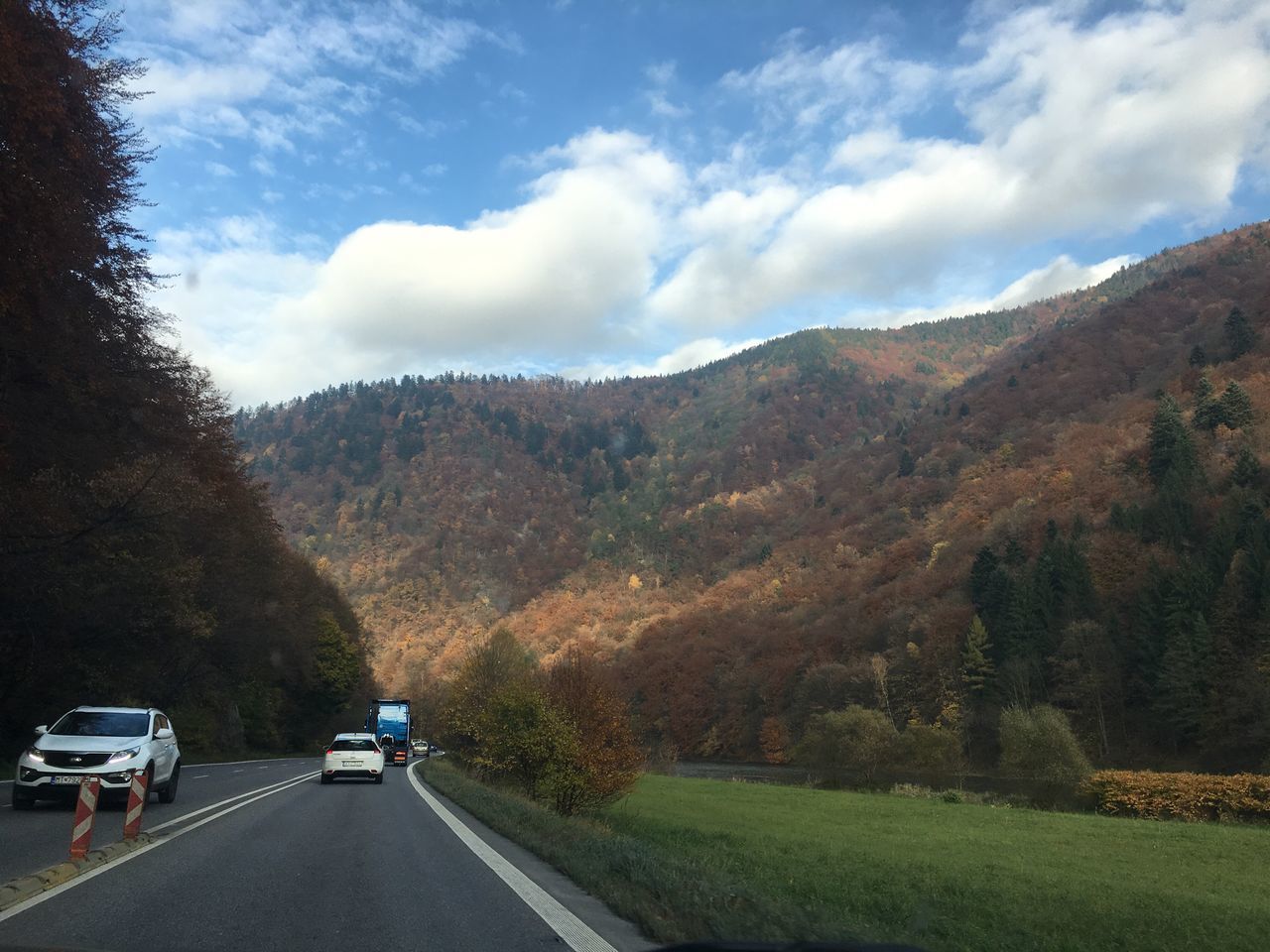 transportation, cloud - sky, road, mountain, the way forward, car, sky, mode of transport, nature, land vehicle, beauty in nature, tree, mountain range, no people, day, outdoors, mountain road