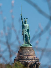 Low angle view of statue against sky