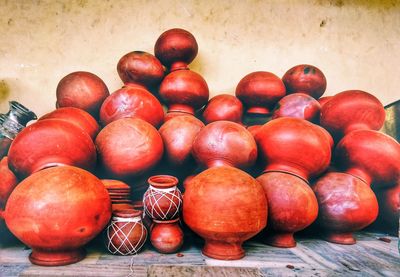 Close-up of pots on table against wall