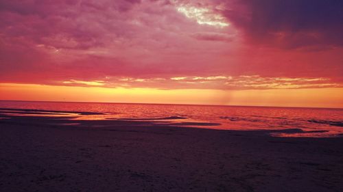 Scenic view of calm sea against cloudy sky