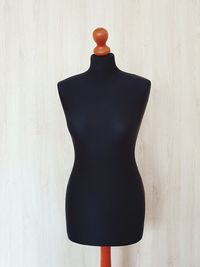 Close-up of mannequin hanging on wall