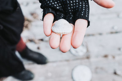 Low section of woman holding hands