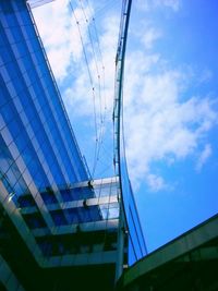 Low angle view of modern building against blue sky