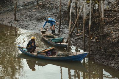 Man on boat moored at shore