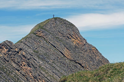 Cross on top of brienzer rothorn against sky