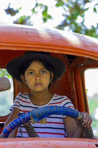 Portrait of girl sitting outdoors