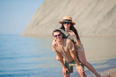 Side view of woman standing at beach