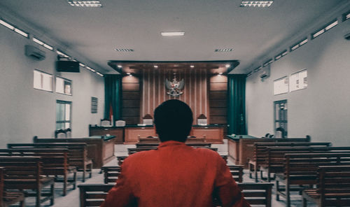 Rear view of man sitting on chair