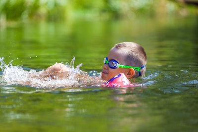 Portrait of woman swimming in lake