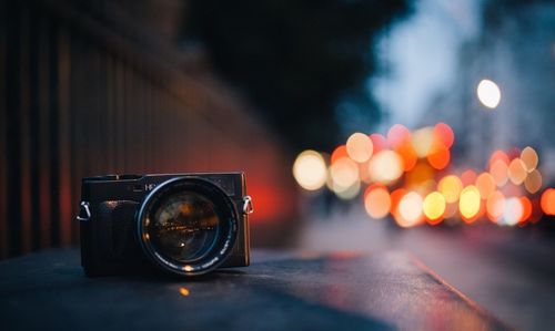 Close-up of camera on illuminated street at night