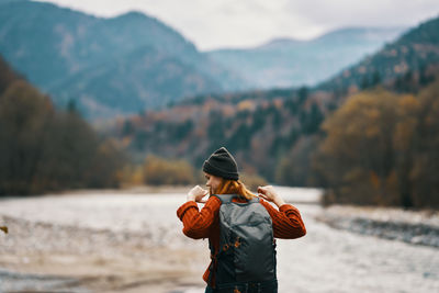 Rear view of man standing on mountain