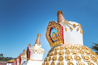 Low angle view of temple against clear blue sky