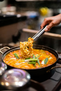 Cropped hand of person preparing food