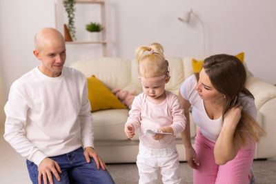 Happy family sitting at home