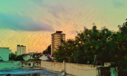 Cityscape against sky at sunset