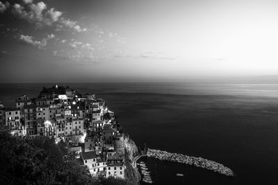 High angle view of buildings by sea against sky