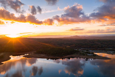 Drone aerial view of a lake reservoir of a dam with reflection on the water in sabugal, portugal