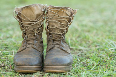 Close-up of dirty boots on grass