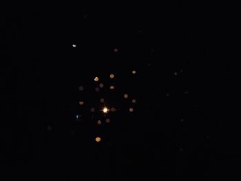 Illuminated lights against black background