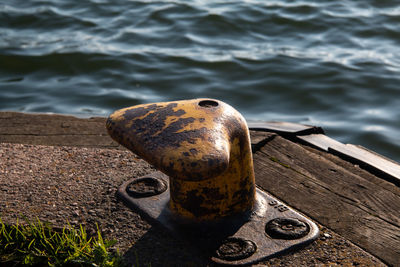 Close-up of rusty metal on pier