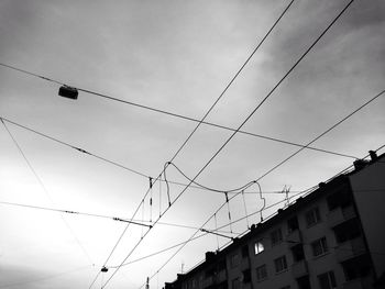 Low angle view of power lines against sky