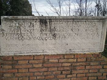 Close-up of text on brick wall