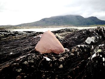 Close-up of rocks on land against sky