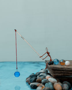 Close-up of fishing net on beach against blue sky