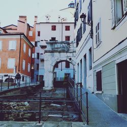 Houses by street in city against sky