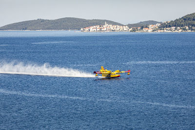 Firefighting airplane collecting water from sea