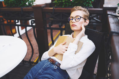 Portrait of young woman using mobile phone