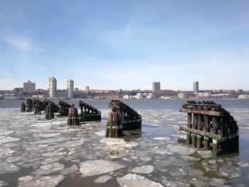 View of sea and buildings against sky