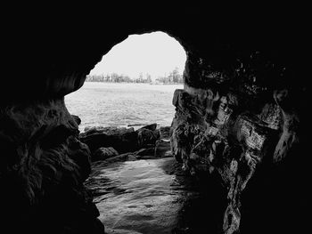 Scenic view of sea seen through cave