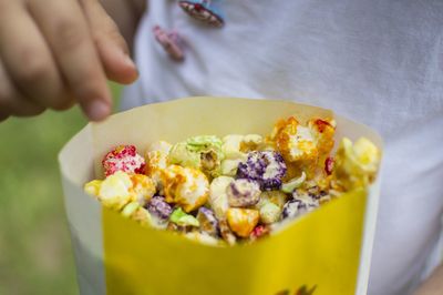 Kid snacking colorful tasty popcorn