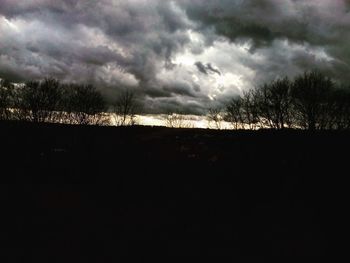 Silhouette of landscape against cloudy sky