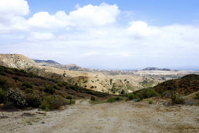 Scenic view of mountains against cloudy sky