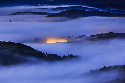 Scenic view of mountains against sky at night