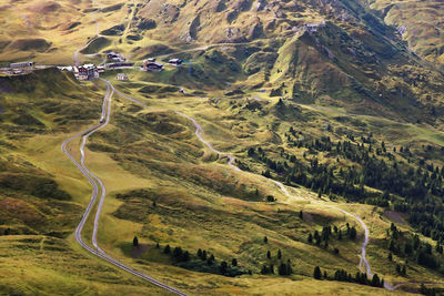 High angle view of railroad tracks amidst grassy field at berner oberland