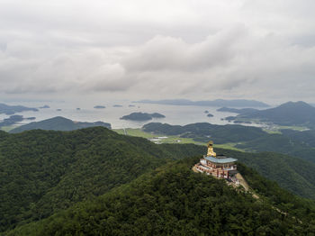 Scenic view of building and mountains against sky