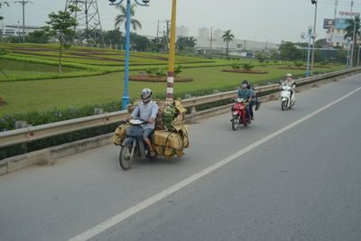People riding motorcycle on street in city