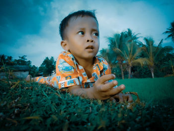 Portrait of cute baby girl on field