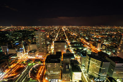 High angle view of illuminated city buildings at night