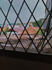 High angle view of buildings seen through window