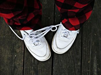 Low section of person with shoelaces tied together