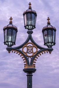 Low angle view of ornate london street light against sky